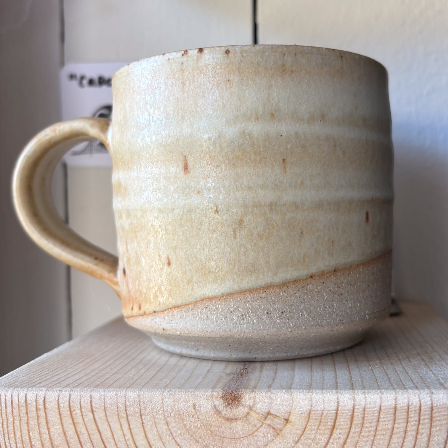 Ceramic mug with a textured surface on a wooden surface