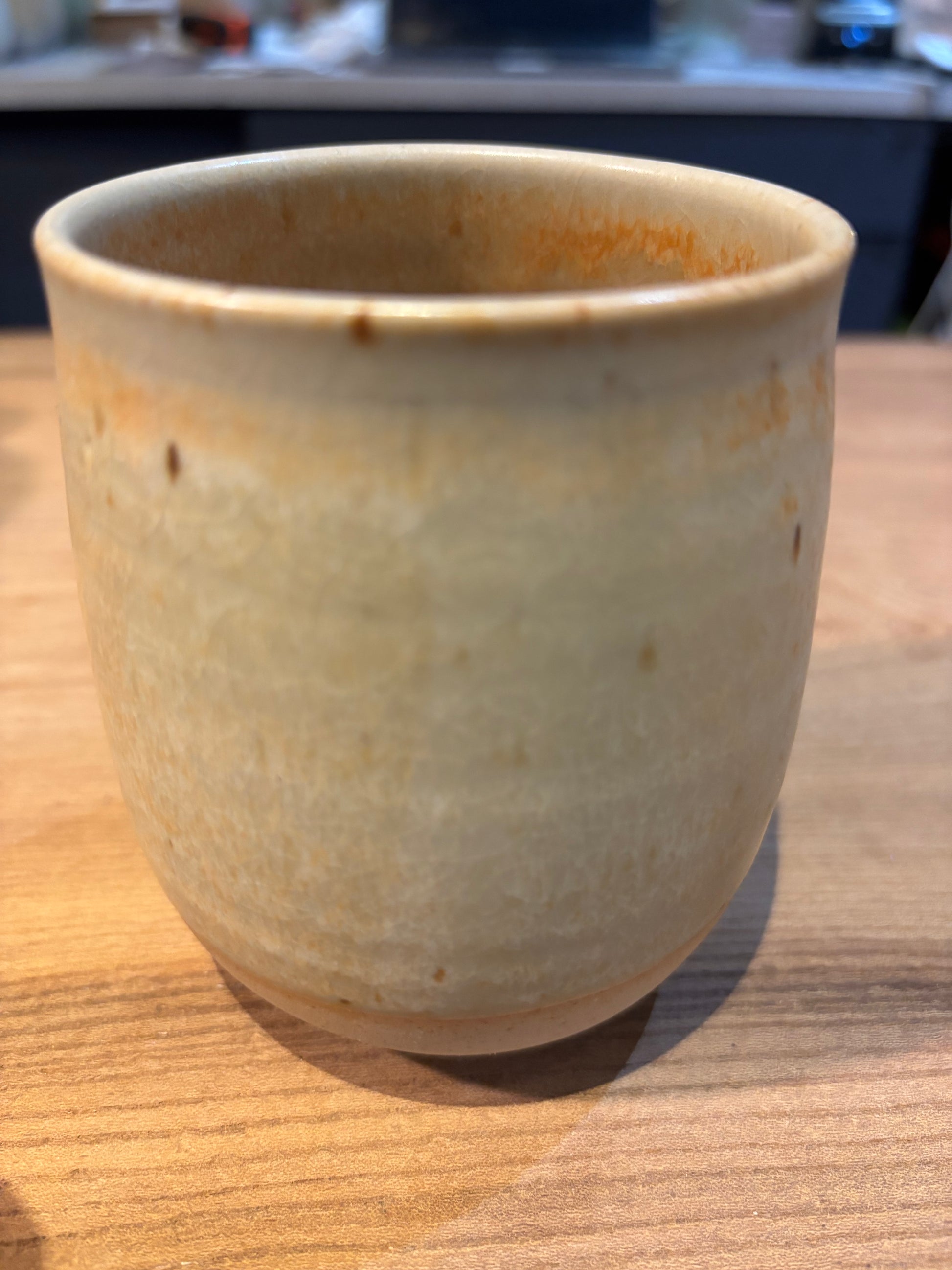 Ceramic cup with a rustic finish on a wooden surface