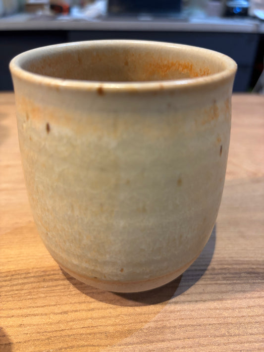 Ceramic cup with a rustic finish on a wooden surface