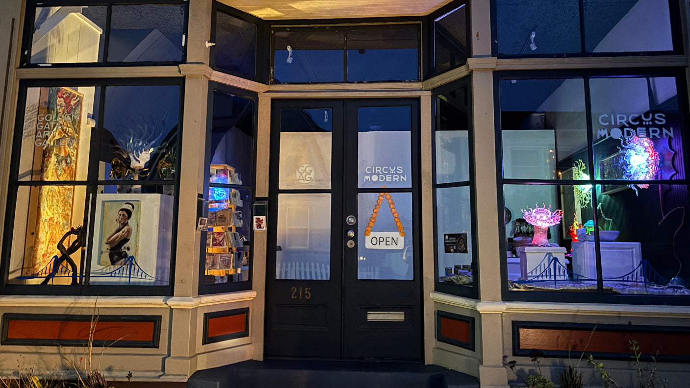 Golden Gate Art Gallery Storefront with large windows displaying various items and a 'Circus Modern' sign.